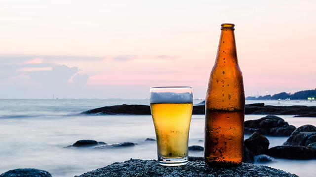 beer with the sea in the background