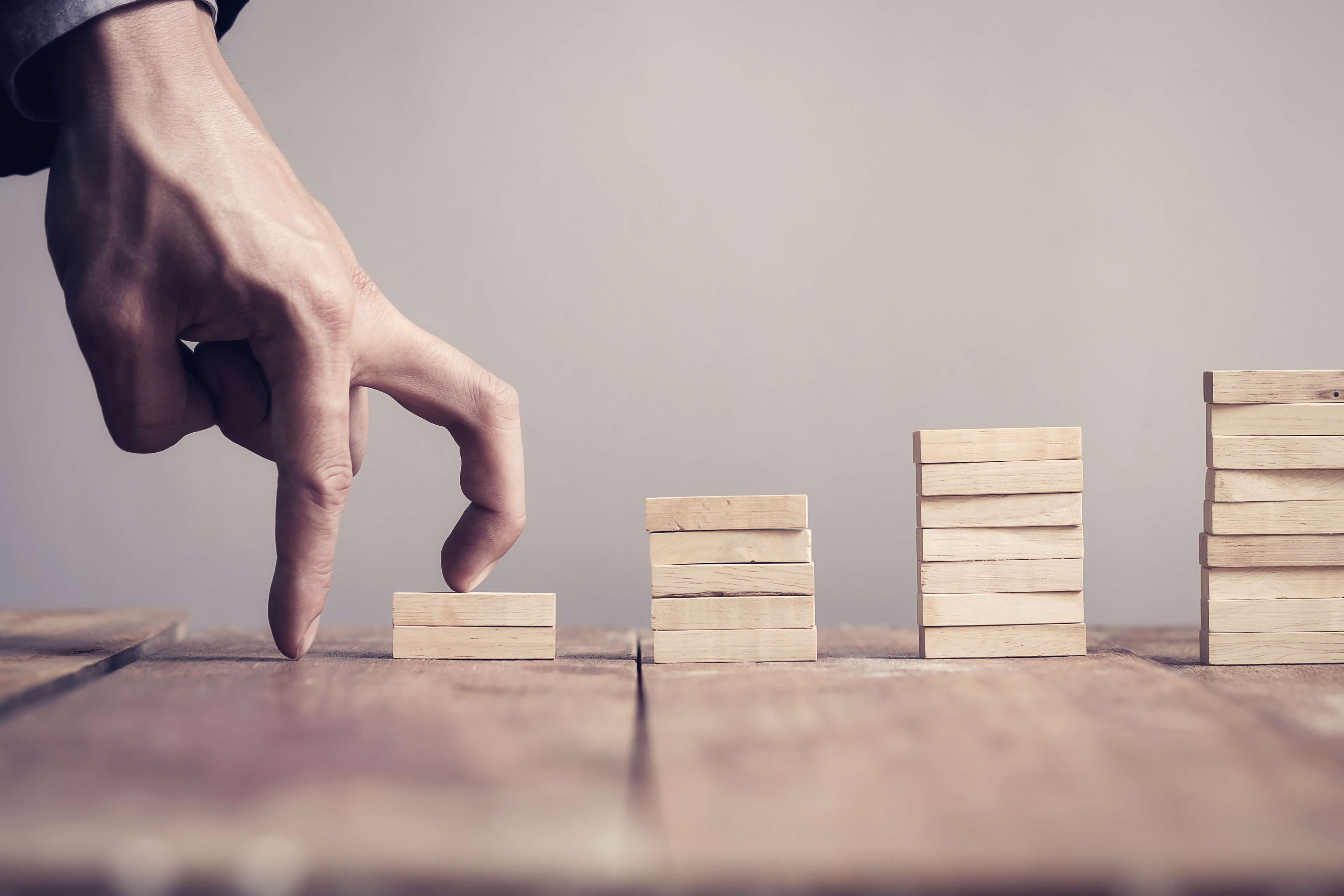 Hand stepping up to success