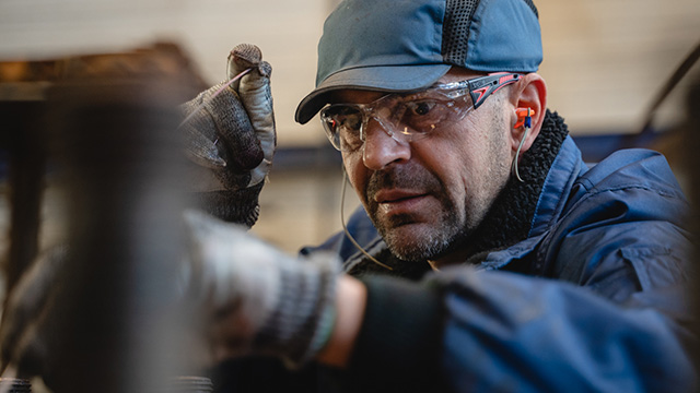 Man performing maintenance on welded plate heat exchanger